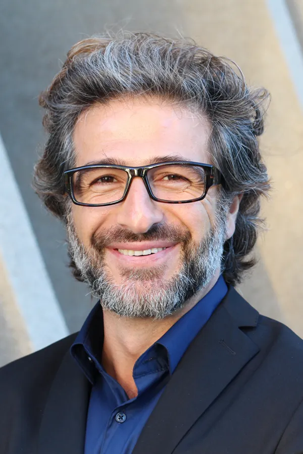 Andropause-and-Low-Testosterone-Treatment A man with glasses, salt and pepper hair and a beard smiling because he received treatment for andropause and low testosterone from Markham Natural Health Centre in Greater Toronto.