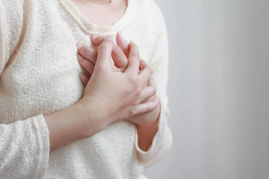 Asthma-Doctor A woman clutches her chest during an asthma attack. Get treatment for asthma from Markham Natural Health Centre in Greater Toronto.