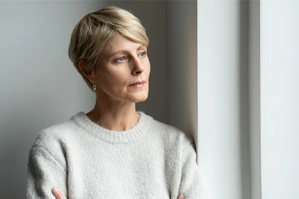 Chronic-Fatigue-Therapy A blond, middle-aged woman looks out the window with a tired expression. Get chronic fatigue treatment from Markham Natural Health Centre in Greater Toronto.
