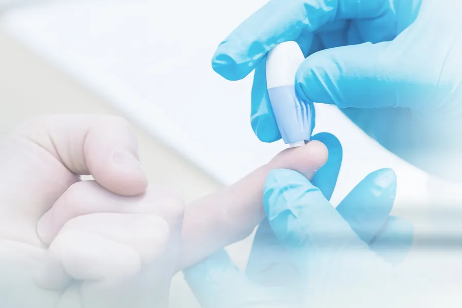 Diabetes-Doctor A doctor's gloved hand pricks a patients finger with to measure blood sugar, symbolizing diabetes treatment from Markham Natural Health Centre in Greater Toronto.