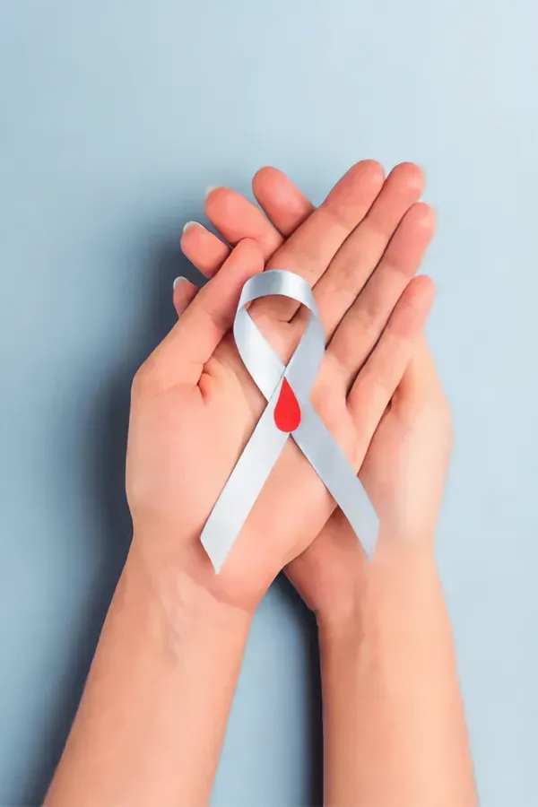 Diabetes-Treatment A woman's hands holding a white ribbon with a red drop symbol on it, symbolizing diabetes treatment from Markham Natural Health Centre in Greater Toronto.