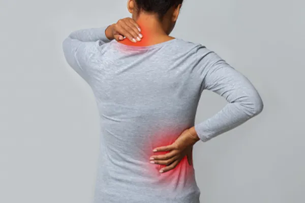 Fibromyalgia-Clinic An image from behind of a woman suffering from Fibromyalgia holding her hands on her neck and lower back. Get fibromyalgia care from Markham Natural Health Centre in Greater Toronto.