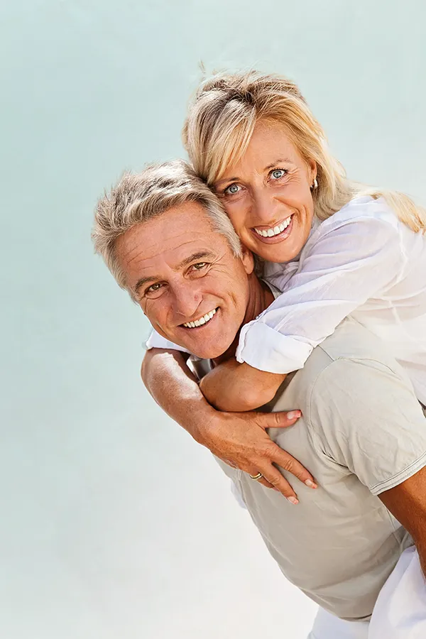 Food-Allergies-Treatment-1 A happy mature couple having fun - the husband is carrying his wife on his back. Get treatment for food allergies from Markham Natural Health Centre in Greater Toronto.
