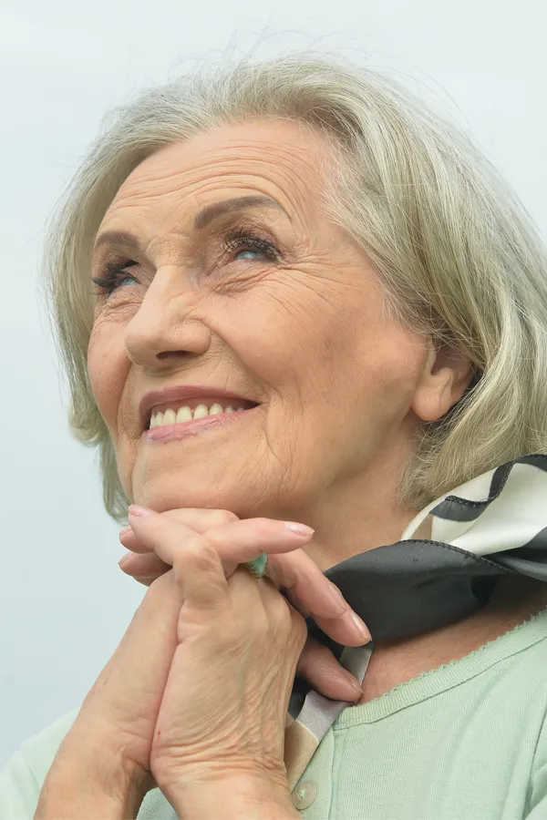 Hot-Flashes-and-Night-Sweats-Treatments An older woman holds her hands together under her chin and looks up at a cool sky smiling. Get treatment for hot flashes and night sweats from Markham Natural Health Centre in Greater Toronto.