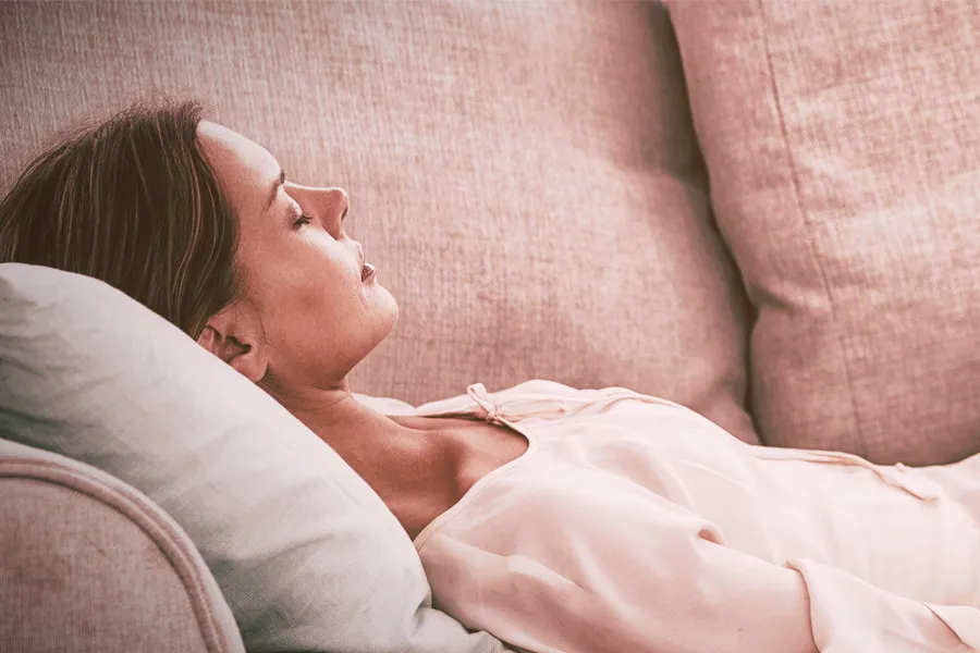 Hypnotherapy-Clinic A woman with closed eyes lays on a couch getting hypnontherapy. Get hypnotherapy from Markham Natural Health Centre in Greater Toronto.