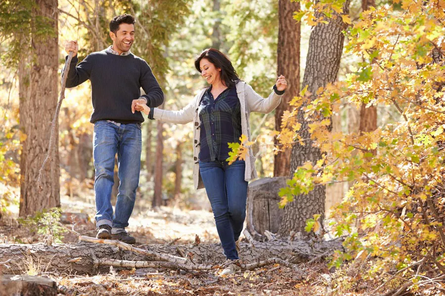 Lyme-Disease-Clinic A couple happily hiking in the forest in fall. Get treatment for Lyme Disease from Markham Natural Health Centre in Greater Toronto.