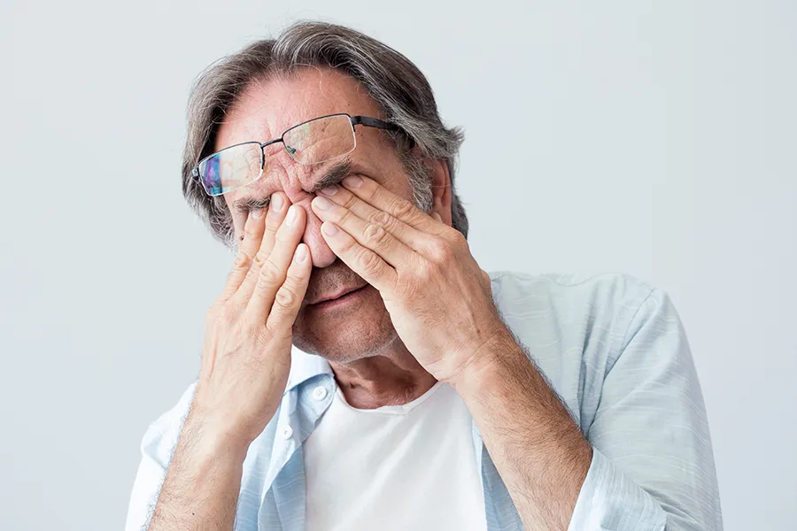 Migraine-Clinic Get migraine relief with Markham Natural Health Centre's functional medicine for migraines treatment in Greater Toronto, represented by an older man rubbing his eyes due to head pain.