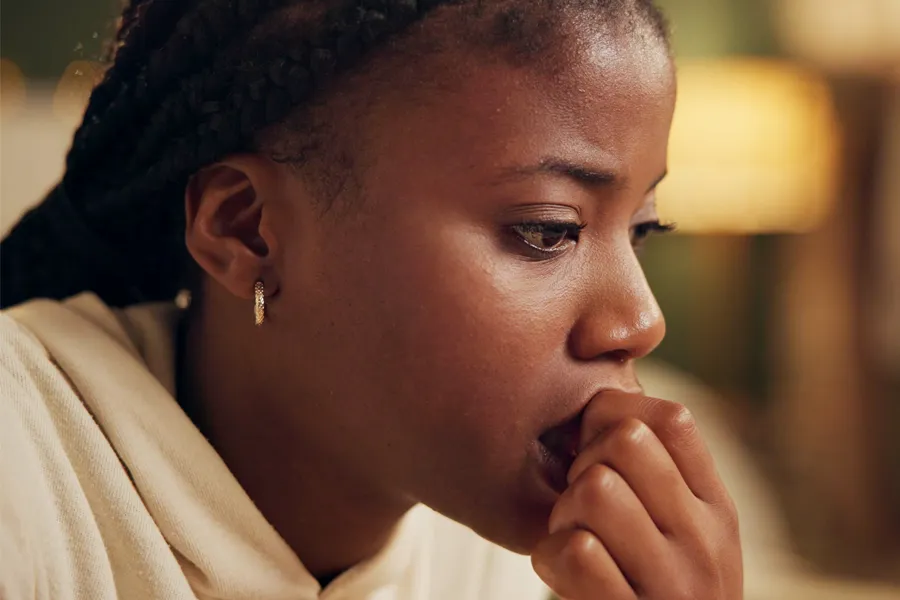 Mood-Imbalance-Clinic A black woman feeling stress bites her nails and looks withdrawn. Get treatment for mood imbalances and stress from Markham Natural Health Centre in Greater Toronto.