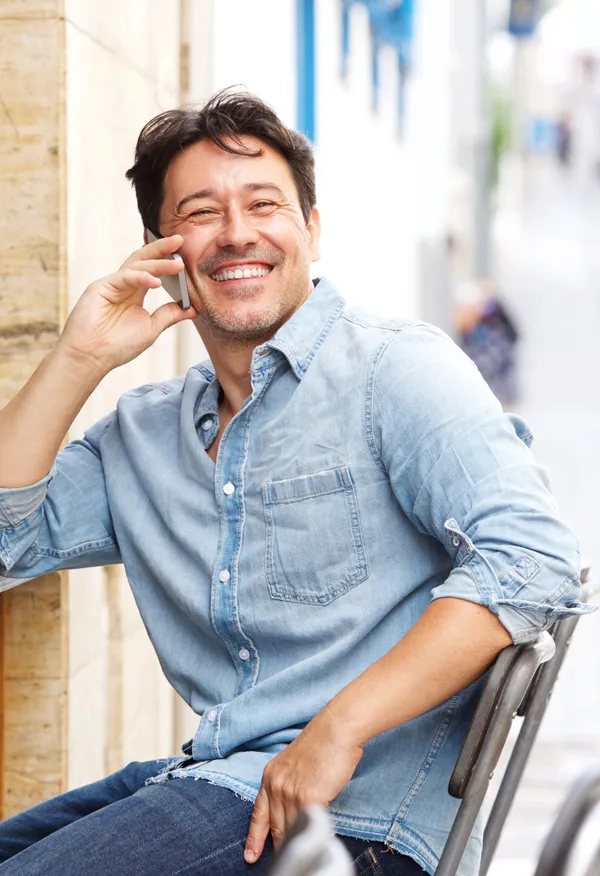 Mood-Imbalance-Treatment A smiling, happy man sits at an outdoor cafe. Get treatment for mood imbalances and stress from Markham Natural Health Centre in Greater Toronto.