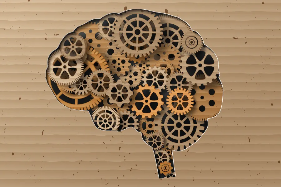 Psychotherapy-and-Counseling-Clinic Paper cut illustration of gears in the shape of a human brain. Schedule psychotherapy and counseling services from Markham Natural Health Centre in Greater Toronto.