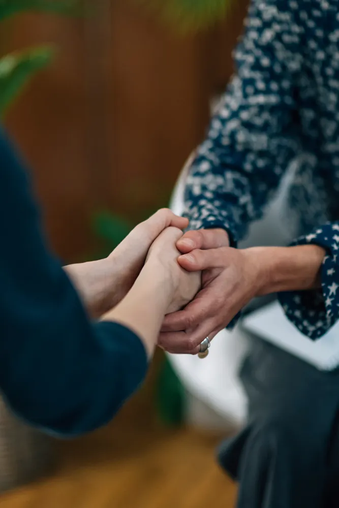 Psychotherapy-and-Counseling-Treatment A therapist comforts a patient by holding their hands. Get psychotherapy and counseling services from Markham Natural Health Centre in Greater Toronto.