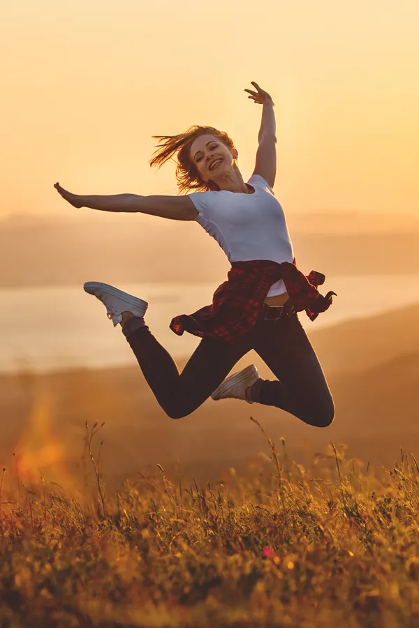 Quantum-Biofeedback-Treatment A woman joyfully jumps in the air. Get quantum biofeedback therapy from Markham Natural Health Centre in Greater Toronto.