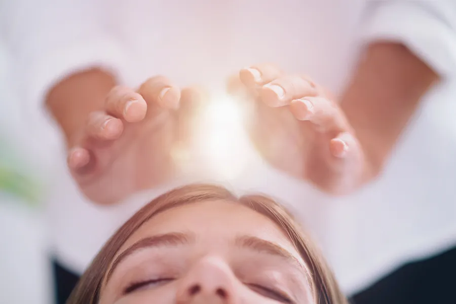 Reiki-Clinic A patient receives Reiki treatment over their forehead. Get Reiki treatment from Markham Natural Health Centre in Greater Toronto.
