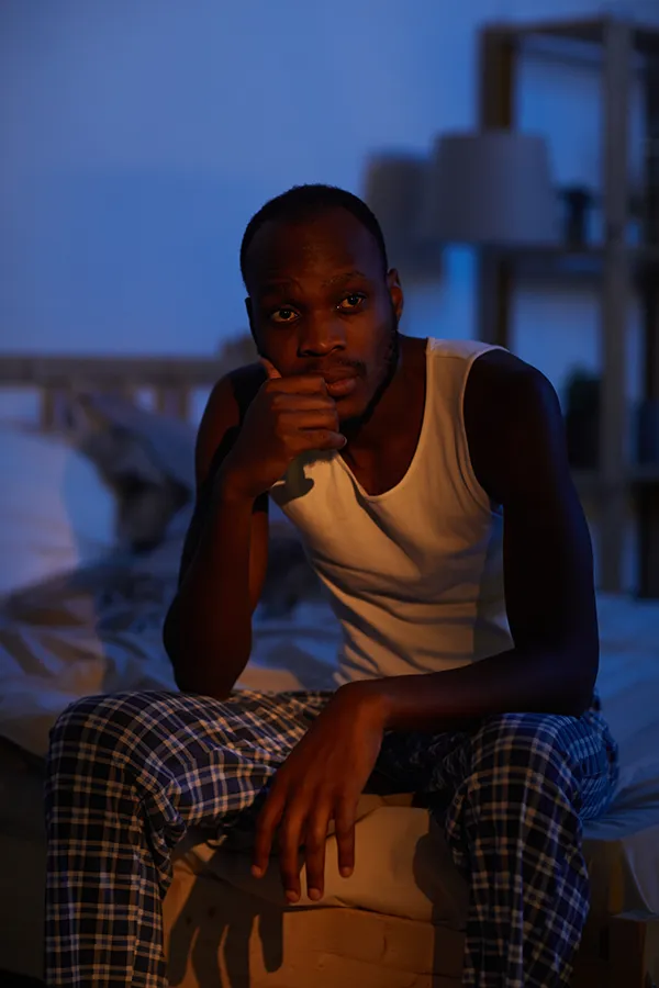 Sleep-Disorders-Treatment A man sits on the edge of his bed concerned that he can't sleep. Get treatment for sleep disorders from Markham Natural Health Centre in Greater Toronto.