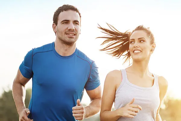 Weight-Loss-Resistance-Doctor A couple happily jogging in the sunlight after receiving effective weight loss resistance care from Markham Natural Health Centre in Greater Toronto.